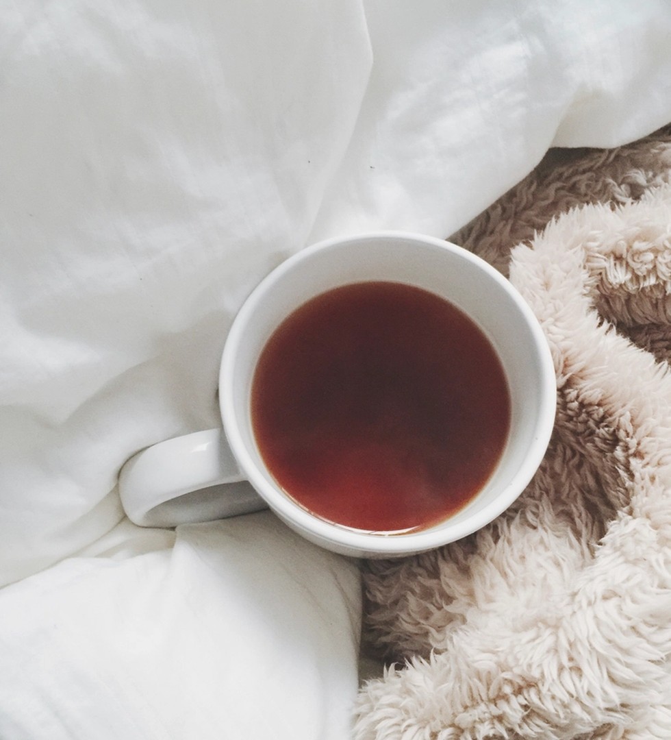 A warm drink resting on a blanket